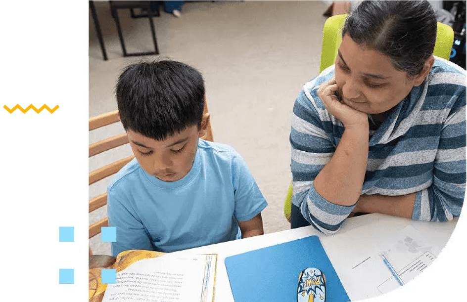 A woman helping her young son with his homework.